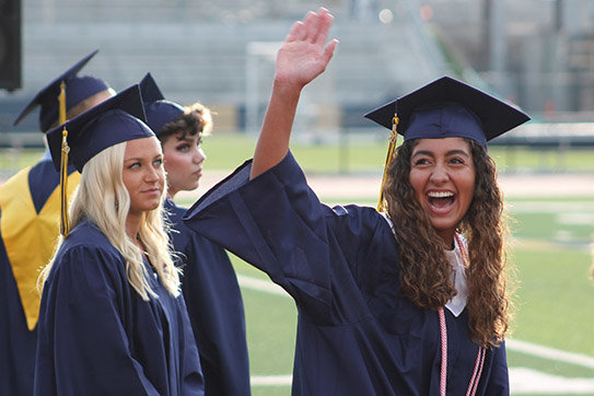 A graduating senior greets her family while entering Helias Catholic High School's Crusader Athletic Complex.